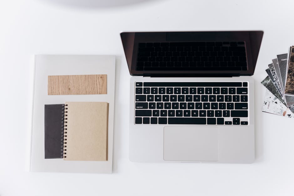 Minimal creator workspace with laptop and notebooks used to plan clips, emails, and follow-up content