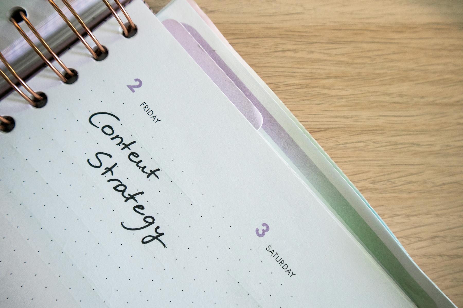 Content strategy planner open on a desk beside a keyboard